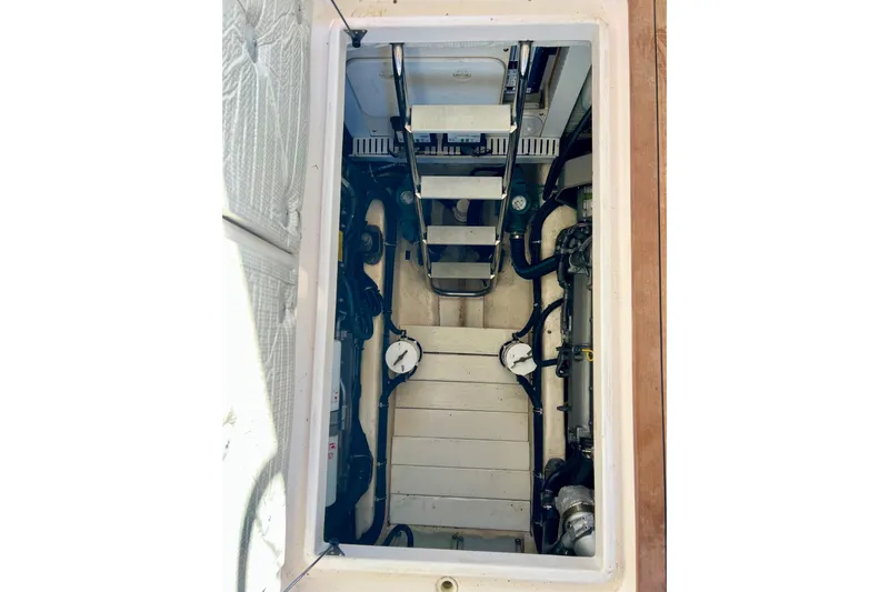 Island Time Yacht Photos Pics Engine compartment of 2006 Sabre 38 Hard Top Express boat, showing mechanical components and ladder.