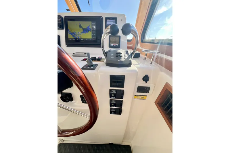 Island Time Yacht Photos Pics 2006 Sabre 38 Hard Top Express helm with navigation controls and wooden steering wheel.