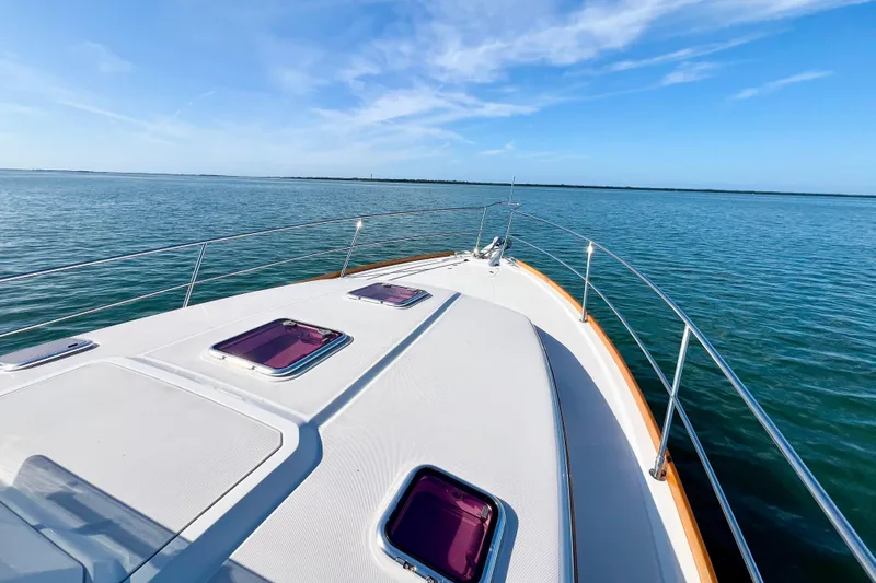 Island Time Yacht Photos Pics 2006 Sabre 38 Hard Top Express yacht cruising on calm blue waters under clear skies.