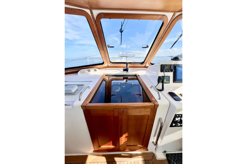 Island Time Yacht Photos Pics 2006 Sabre 38 Hard Top Express helm with navigation equipment and wooden cabinetry.