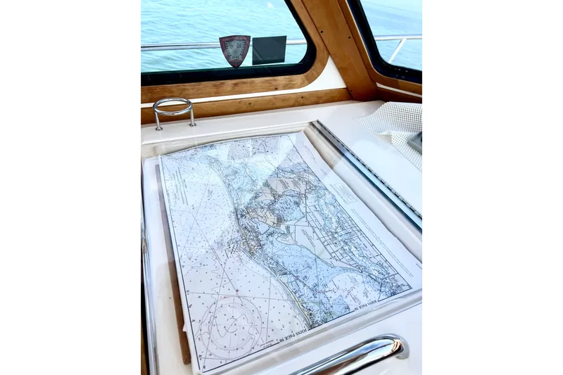 Island Time Yacht Photos Pics Nautical chart on 2006 Sabre 38 Hard Top Express boat, with ocean view through window.