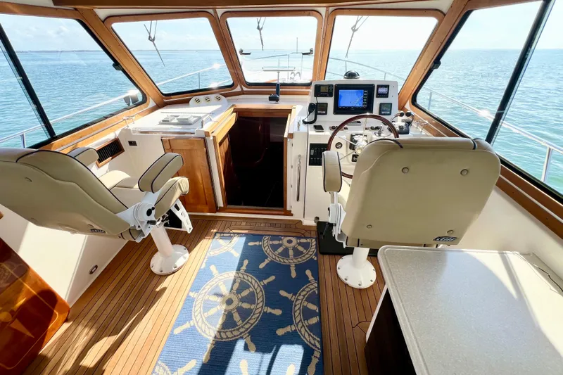 Island Time Yacht Photos Pics 2006 Sabre 38 Hard Top Express helm with ocean view, featuring navigation equipment and seating.