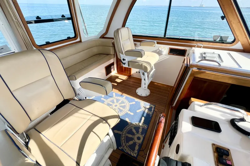 Island Time Yacht Photos Pics Interior of 2006 Sabre 38 Hard Top Express yacht with beige seating and ocean view.