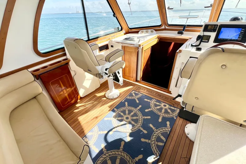 Island Time Yacht Photos Pics Interior of 2006 Sabre 38 Hard Top Express yacht with helm, seating, and nautical decor.