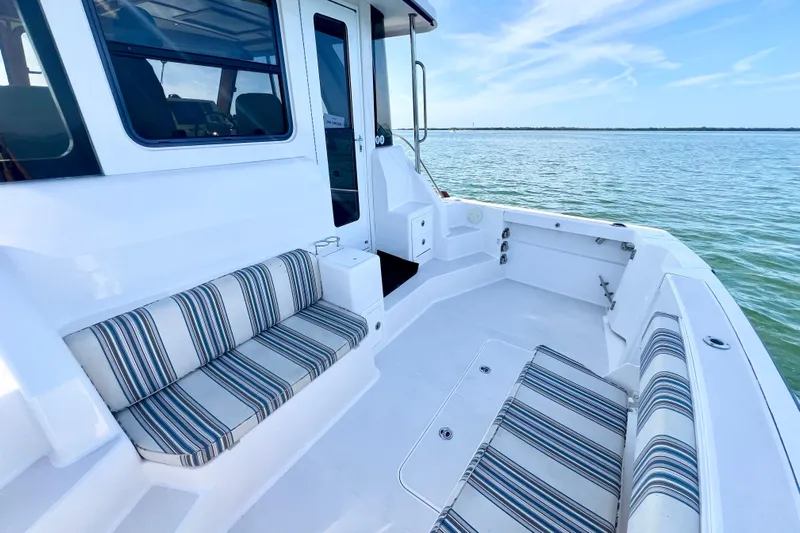 Island Time Yacht Photos Pics 2006 Sabre 38 Hard Top Express boat with striped seating, docked on calm water.
