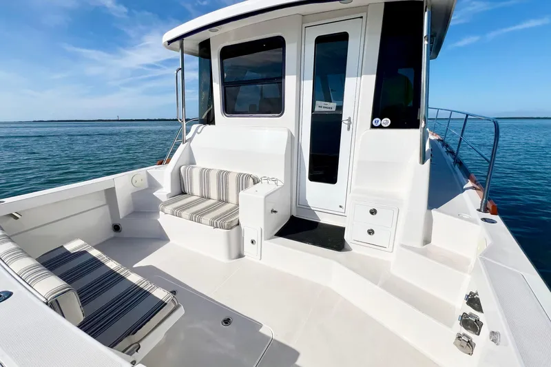 Island Time Yacht Photos Pics 2006 Sabre 38 Hard Top Express boat with striped seating, docked on calm water.