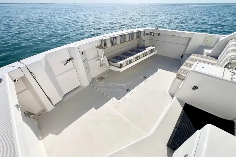 Island Time Yacht Photos Pics 2006 Sabre 38 Hard Top Express boat deck with striped seating, overlooking calm ocean waters.