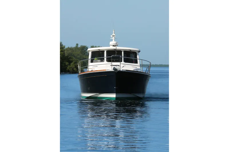 Island Time Yacht Photos Pics 2006 Sabre 38 Hard Top Express boat on calm water, front view.
