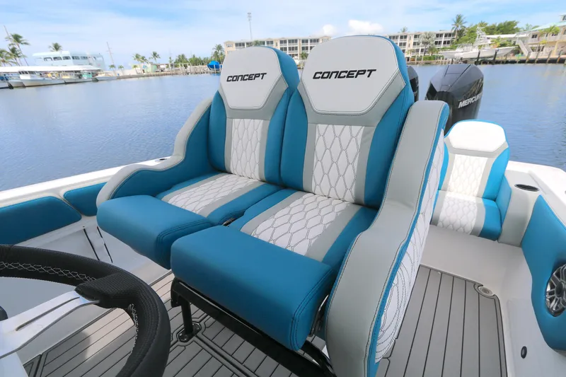  Yacht Photos Pics 2025 Concept 30 Open Deck boat with stylish blue and white seating, docked by the water.