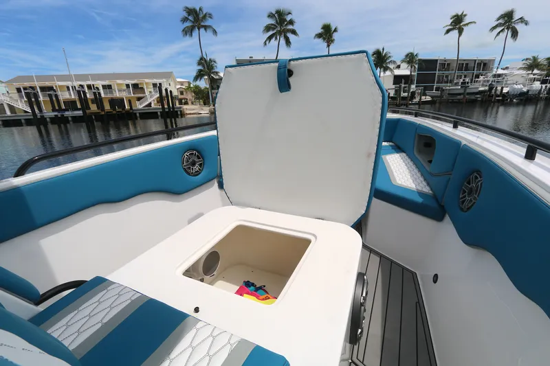  Yacht Photos Pics 2025 Concept 30 Open Deck boat interior with open storage compartment, blue seating, and waterfront view.