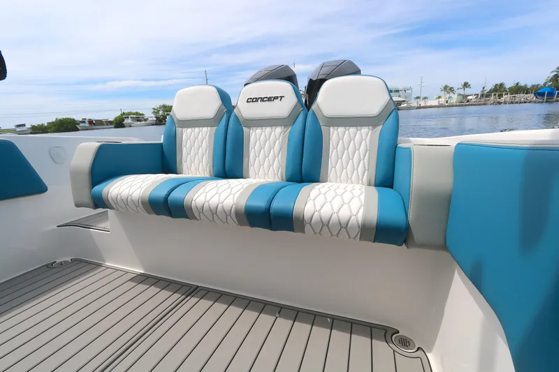  Yacht Photos Pics 2025 Concept 30 Open Deck boat seating with blue and white upholstery, dockside view.