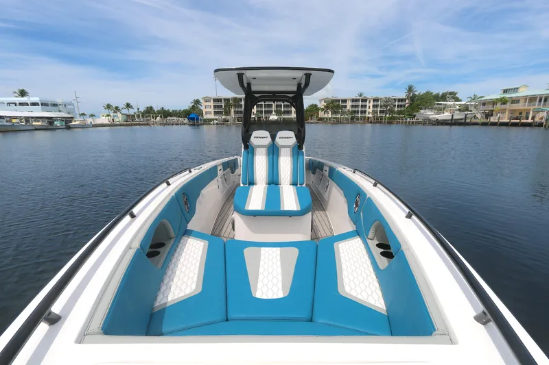  Yacht Photos Pics 2025 Concept 30 Open Deck boat with blue and white seating on calm water.