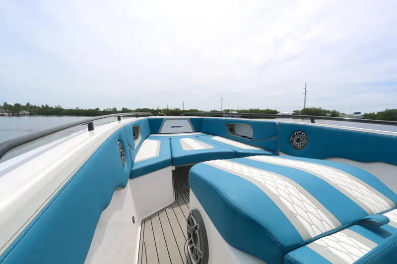  Yacht Photos Pics 2025 Concept 30 Open Deck boat with blue and white seating, on calm water.