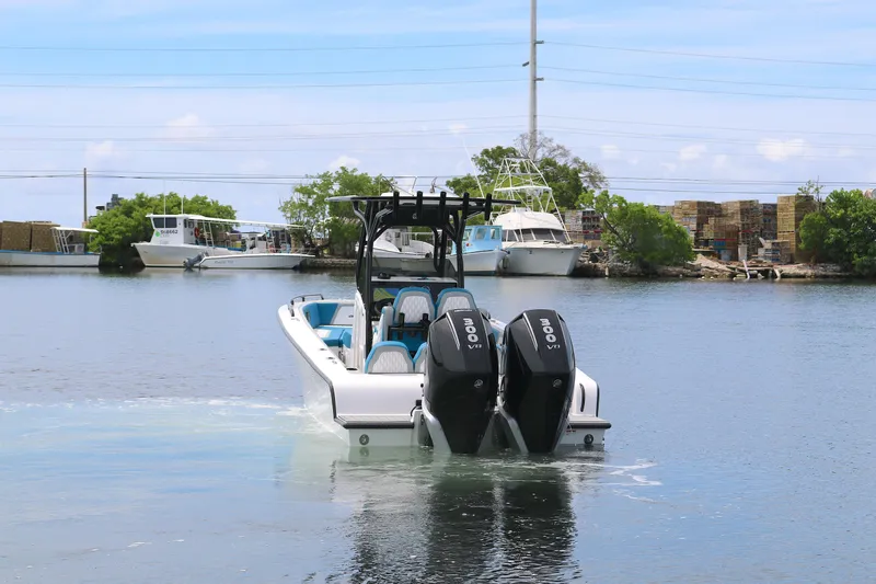  Yacht Photos Pics 2025 Concept 30 Open Deck boat with dual engines on calm water.
