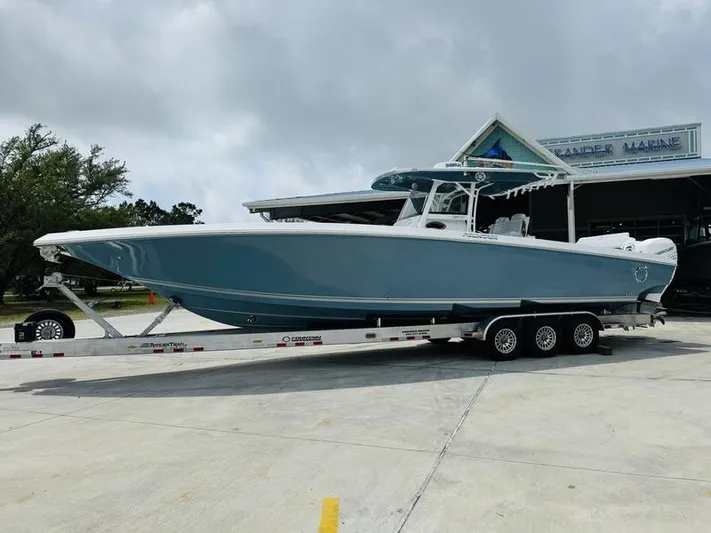  Yacht Photos Pics 2020 Fountain 38cc boat on a trailer outside a marine dealership.