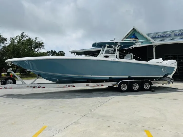  Yacht Photos Pics 2020 Fountain 38cc boat on a trailer outside a marina.
