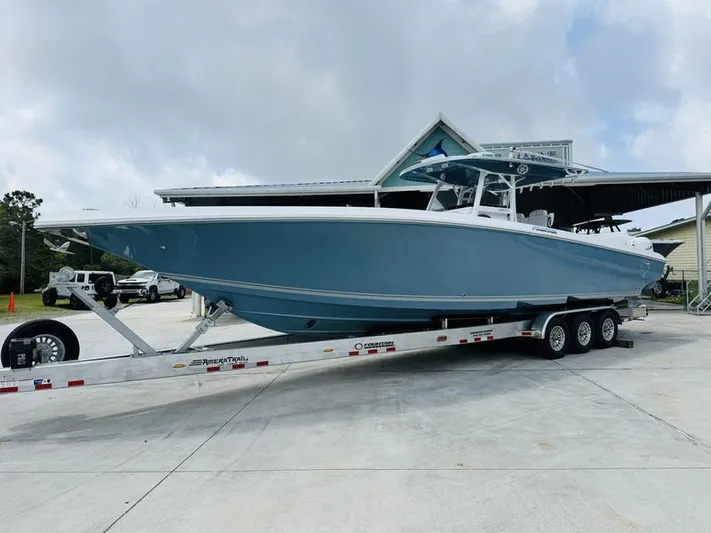 Yacht Photos Pics 2020 Fountain 38cc boat on a trailer in a driveway.