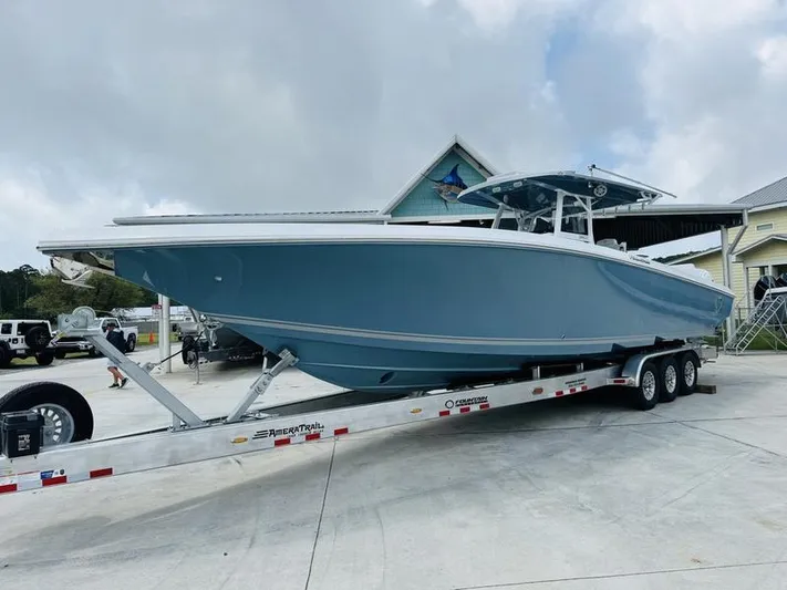  Yacht Photos Pics 2020 Fountain 38cc boat on a trailer in a marina.