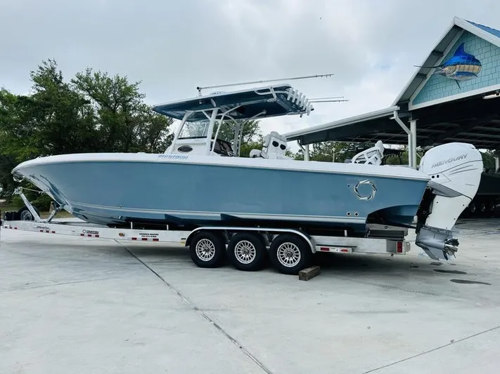  Yacht Photos Pics 2020 Fountain 38cc boat on a triple-axle trailer in a marina.