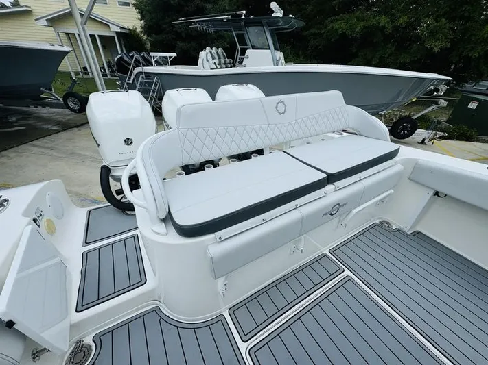  Yacht Photos Pics 2020 Fountain 38cc boat with white seating and dual outboard motors.