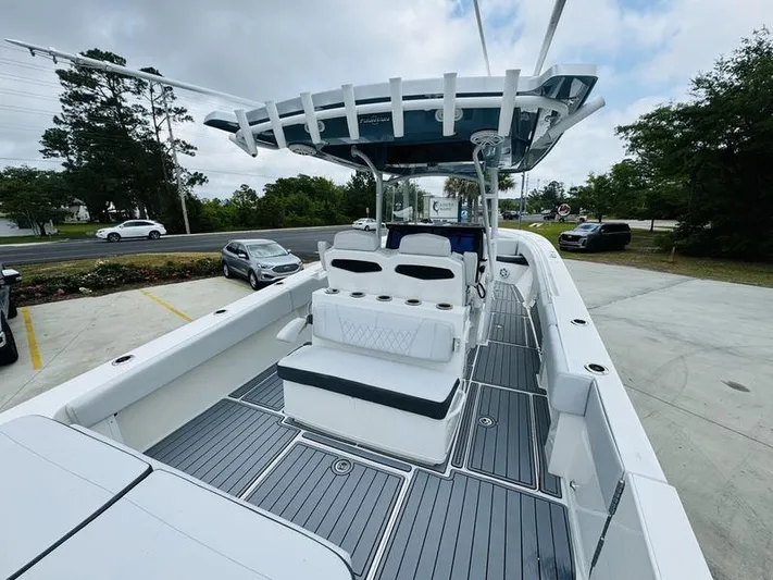  Yacht Photos Pics 2020 Fountain 38cc boat with spacious deck and seating, parked on a lot.