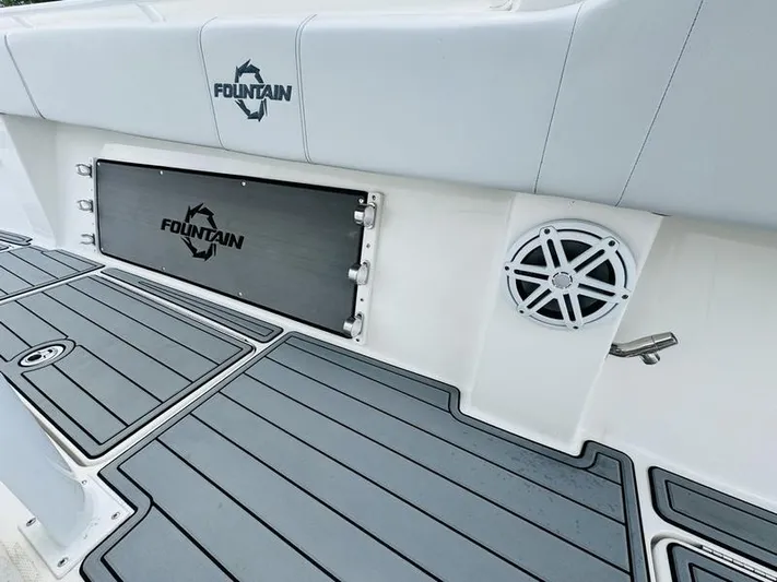  Yacht Photos Pics 2020 Fountain 38cc boat interior with logo, speaker, and storage compartment.