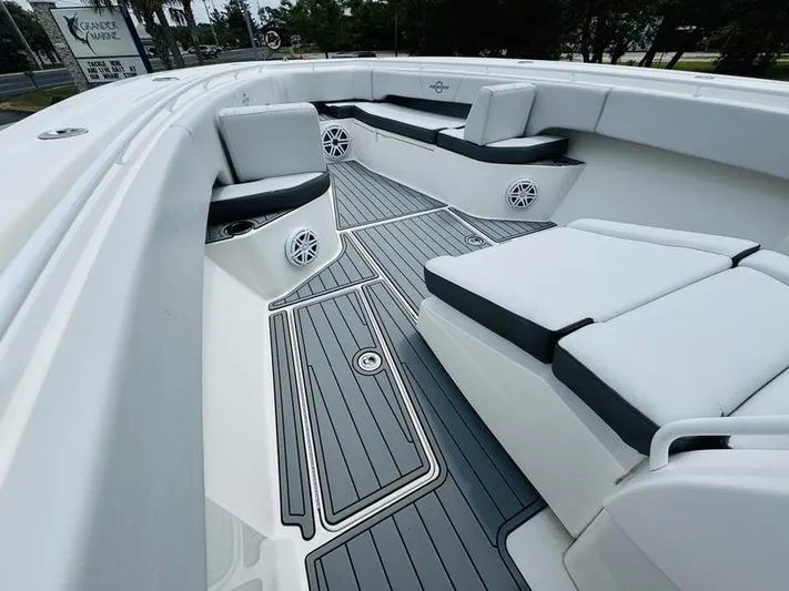  Yacht Photos Pics 2020 Fountain 38cc boat interior with cushioned seating and deck speakers.
