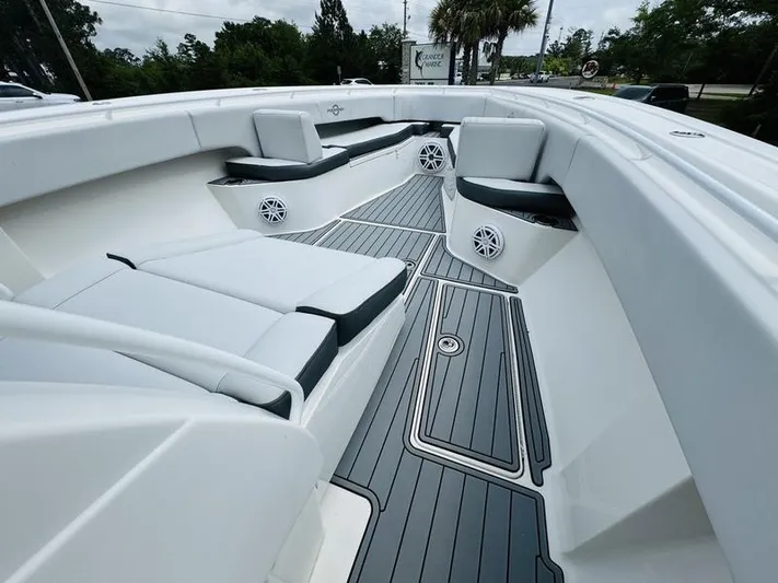  Yacht Photos Pics 2020 Fountain 38cc boat interior with cushioned seating and marine speakers.