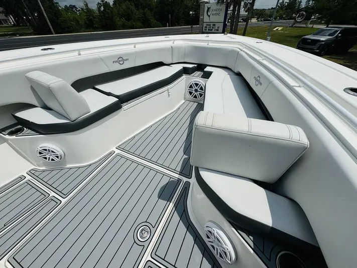  Yacht Photos Pics 2020 Fountain 38cc boat interior with white seating and gray flooring.