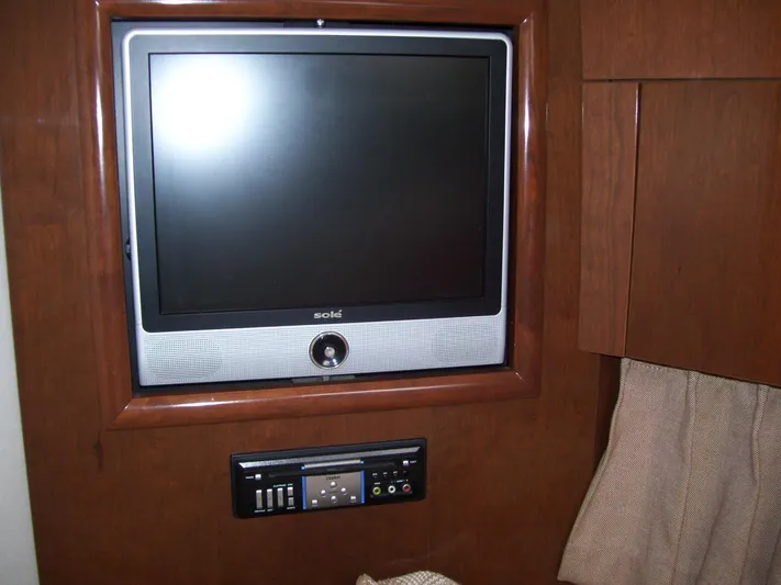  Yacht Photos Pics Flat-screen TV and control panel in 2007 Carver 43 Motor Yacht interior.