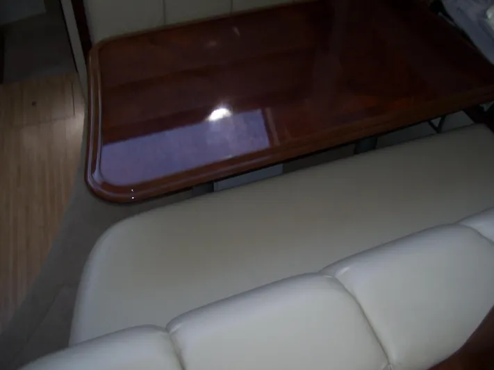  Yacht Photos Pics Interior of 2007 Carver 43 Motor Yacht with wooden table and beige seating.