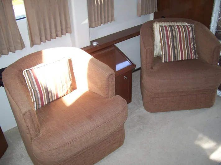  Yacht Photos Pics Interior of 2007 Carver 43 Motor Yacht with two brown armchairs and striped cushions.