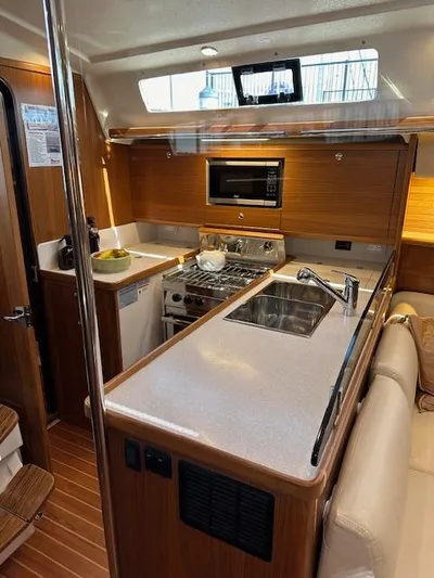 C426 #115 Yacht Photos Pics Modern kitchen in 2025 Catalina 426 yacht with wood finish and stainless appliances.