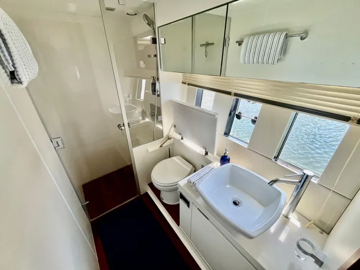  Yacht Photos Pics Luxurious bathroom in 2013 Fairline Targa 50 GT yacht with modern fixtures and large windows.