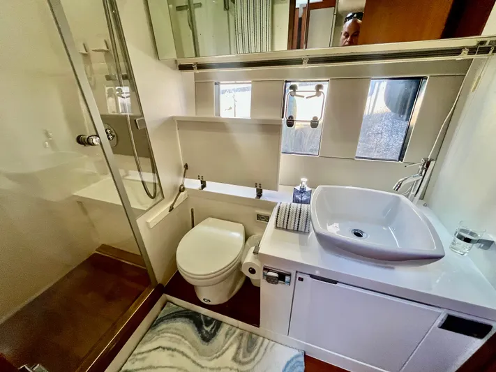  Yacht Photos Pics Luxurious bathroom in 2013 Fairline Targa 50 GT yacht with modern fixtures and glass shower.