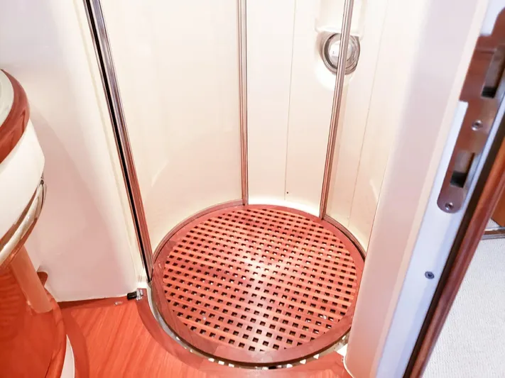  Yacht Photos Pics Shower area in 2004 Azimut 62 Flybridge yacht with circular wooden floor.