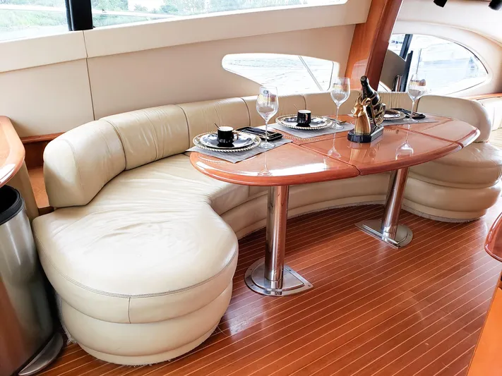 Yacht Photos Pics Luxurious interior of 2004 Azimut 62 Flybridge yacht with elegant dining setup.
