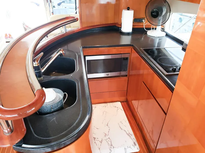  Yacht Photos Pics Luxurious kitchen area on a 2004 Azimut 62 Flybridge yacht with modern amenities.