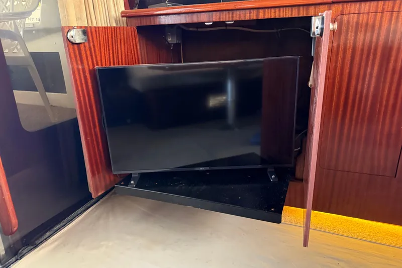 Caribbean Express Yacht Photos Pics Flat-screen TV in wooden cabinet on a 1984 Custom 38 boat.