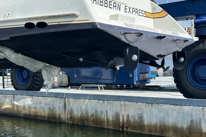 Caribbean Express Yacht Photos Pics 1984 Custom 38 boat on dry dock, showcasing propeller and hull details.