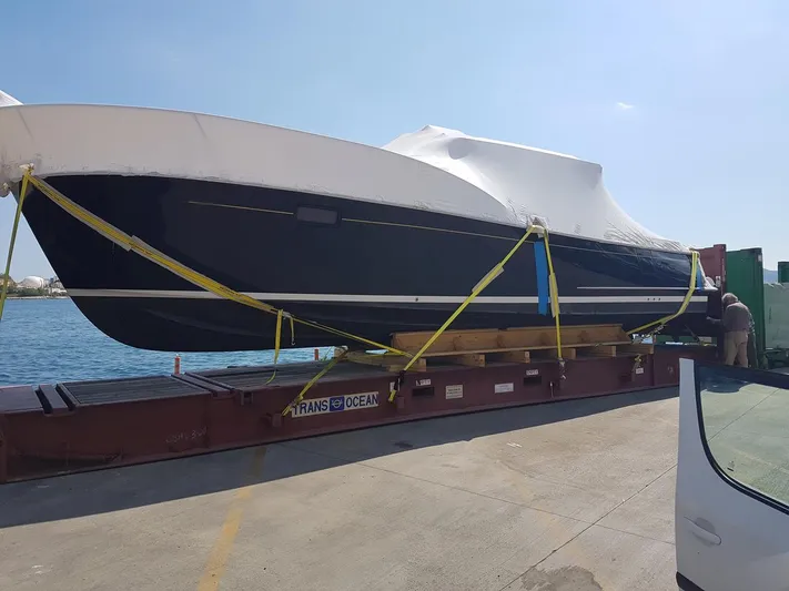  Yacht Photos Pics 2016 MJM 36Z boat secured on a trailer at a dockside.