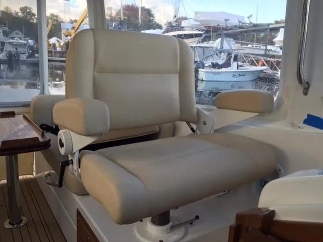  Yacht Photos Pics Luxurious captain's chair on 2016 MJM 36Z yacht, docked at marina.