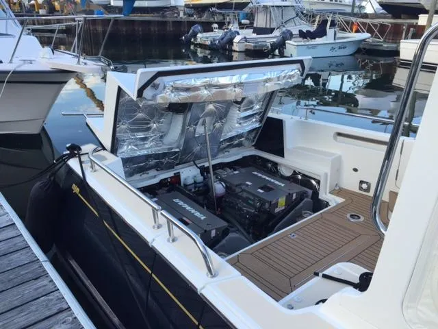  Yacht Photos Pics Engine compartment of a 2016 MJM 36Z boat, open at a marina dock.