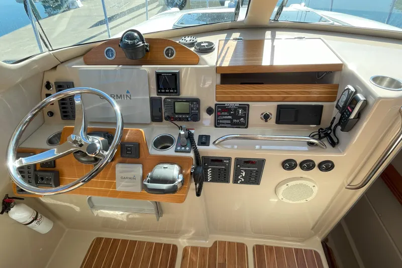 Sweet Jane Yacht Photos Pics 2015 Aspen C100 boat dashboard with Garmin navigation, steering wheel, and control panels.