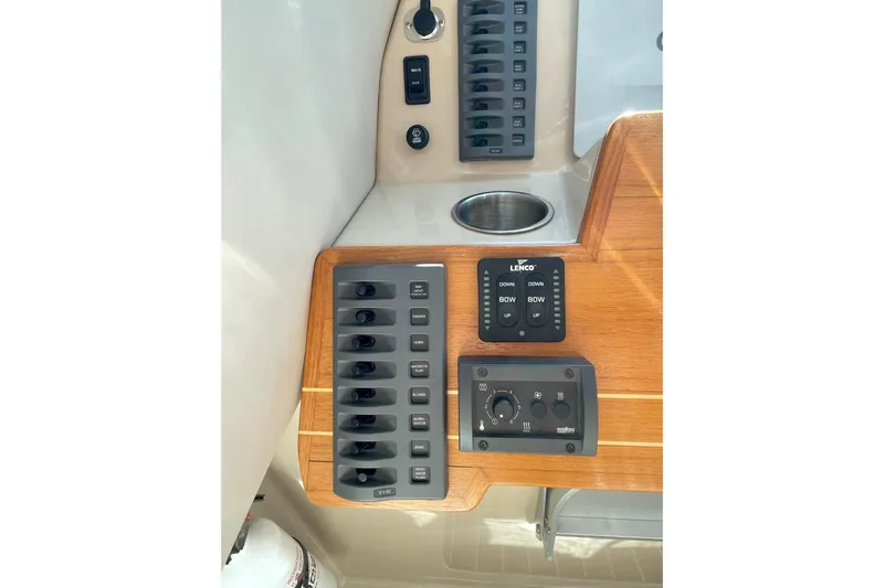 Sweet Jane Yacht Photos Pics Control panel of a 2015 Aspen C100 boat with switches and Lenco trim tab controls.