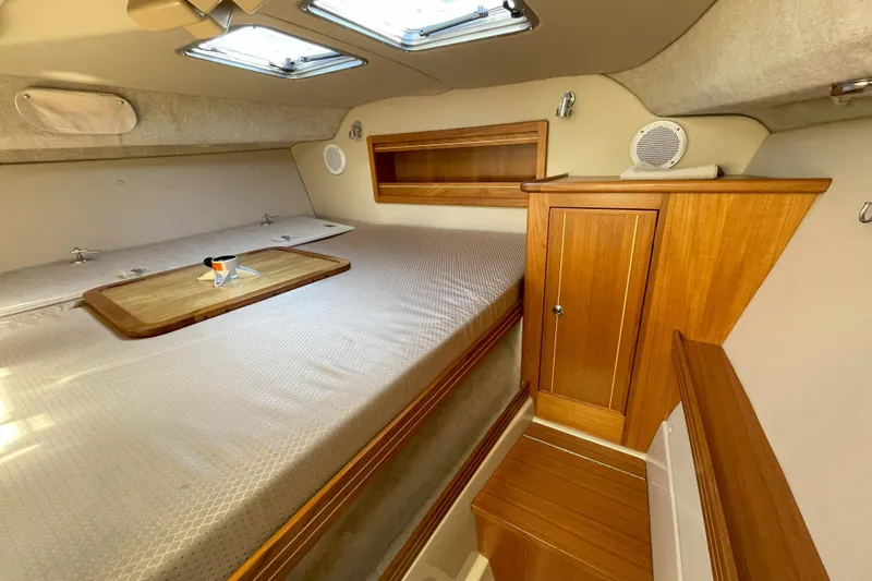 Sweet Jane Yacht Photos Pics Cozy cabin interior of 2015 Aspen C100 boat with wooden cabinetry and skylights.