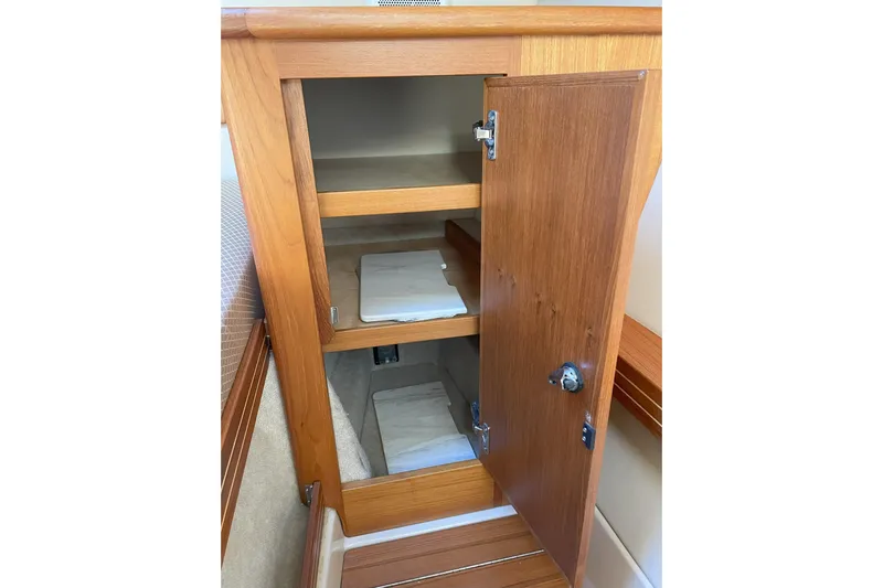 Sweet Jane Yacht Photos Pics Wooden cabinet with open door and shelves inside Aspen C100, 2015 model.