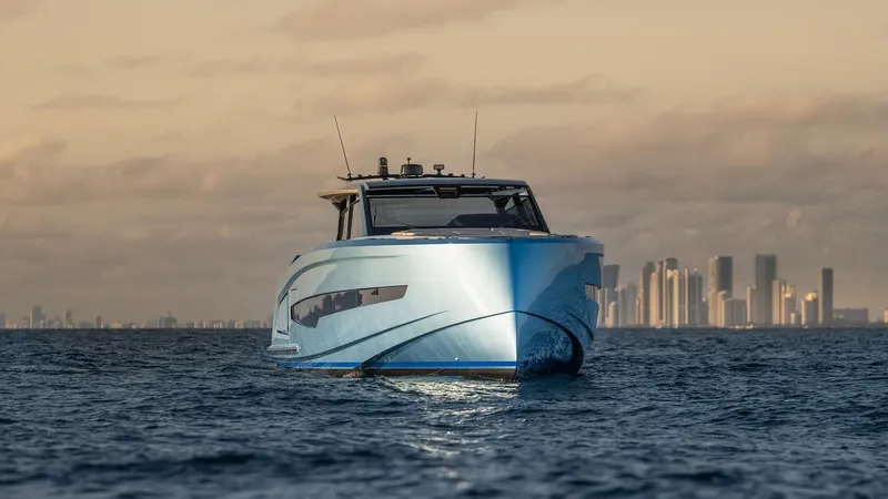 Chapter 3 Yacht Photos Pics 2024 Vanquish Yachts VQ70 cruising on open water with city skyline backdrop.