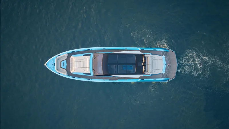 Chapter 3 Yacht Photos Pics 2024 Vanquish Yachts VQ70 luxury yacht, aerial view, cruising on open water.