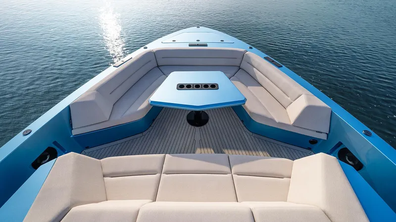 Chapter 3 Yacht Photos Pics 2024 Vanquish Yachts VQ70 luxury yacht deck with seating and table on calm water.